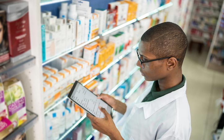 Pharmacist checking stock
